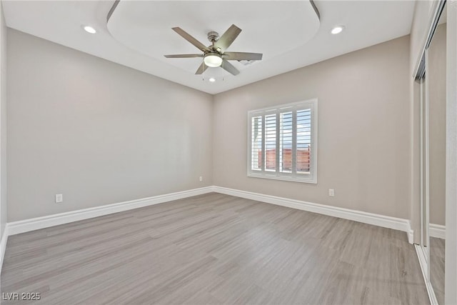unfurnished bedroom featuring recessed lighting, light wood finished floors, and baseboards