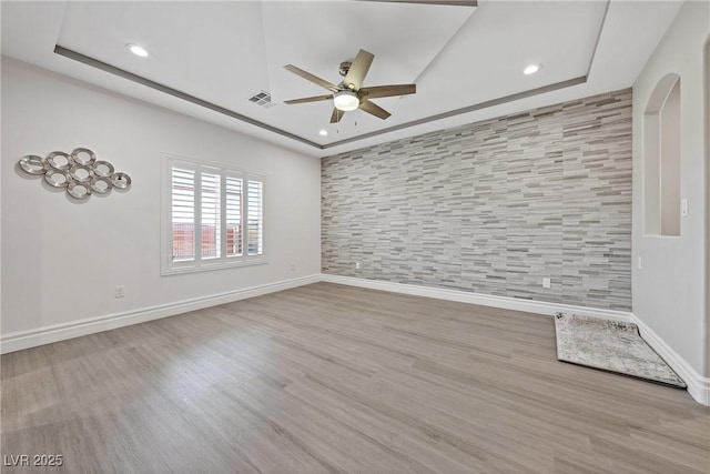spare room featuring a ceiling fan, baseboards, and recessed lighting