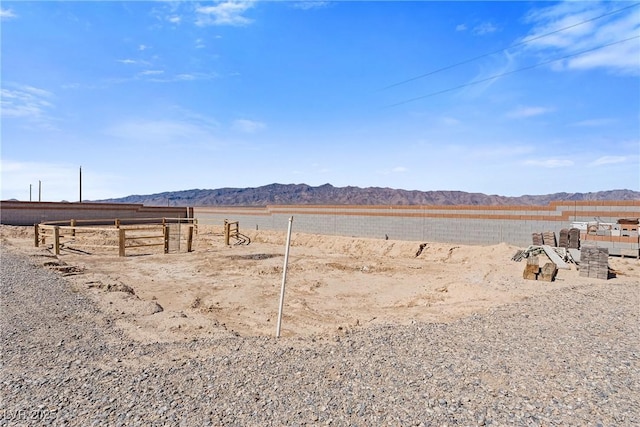 view of yard featuring fence and a mountain view