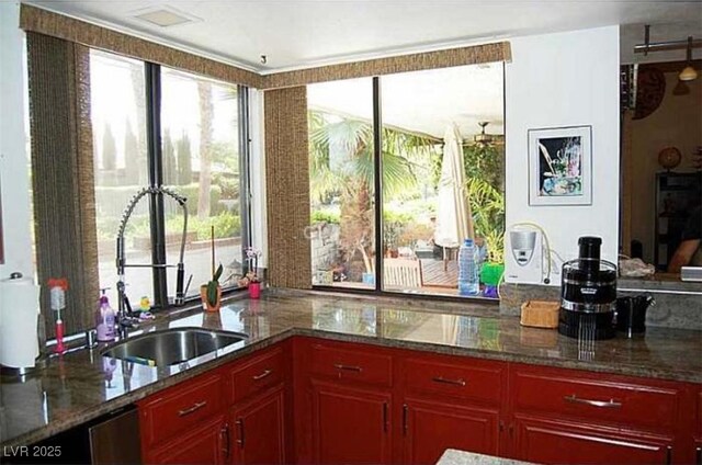 2569 Malabar Ave, Las Vegas, NV 89121 - kitchen with dark brown cabinets and stone countertops