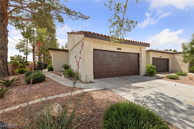 2569 Malabar Ave, Las Vegas, NV 89121 - mediterranean / spanish-style house with a garage, stucco siding, concrete driveway, and a tiled roof