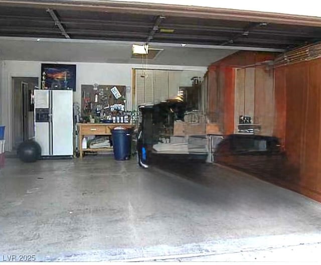 2569 Malabar Ave, Las Vegas, NV 89121 - garage with white fridge with ice dispenser and a garage door opener