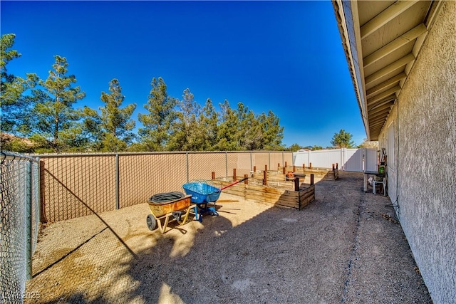 view of yard with a fenced backyard and a vegetable garden