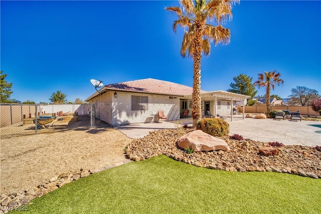1131 China St, Pahrump, NV 89048 - rear view of property featuring a patio area, stucco siding, and a pergola