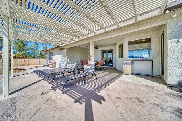 view of patio / terrace featuring fence, french doors, and a pergola