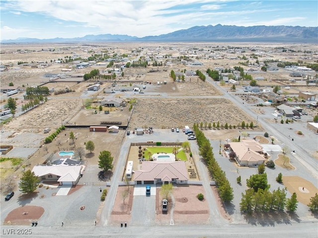 bird's eye view with a desert view and a mountain view