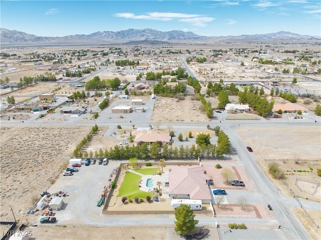 birds eye view of property with a mountain view
