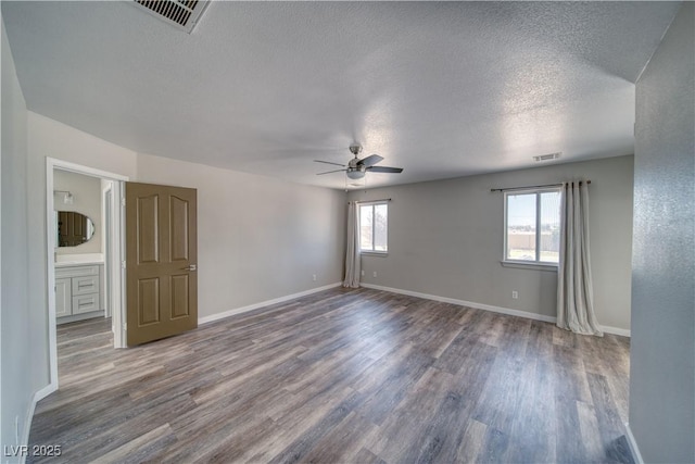1131 China St, Pahrump, NV 89048 - empty room with a ceiling fan, wood finished floors, a textured ceiling, and baseboards