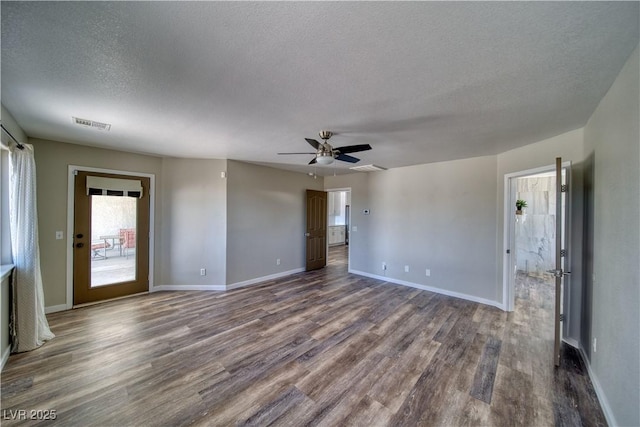 1131 China St, Pahrump, NV 89048 - spare room with a textured ceiling, dark wood-style flooring, a ceiling fan, and baseboards