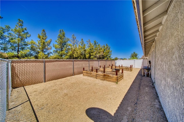 1131 China St, Pahrump, NV 89048 - fenced backyard with a vegetable garden