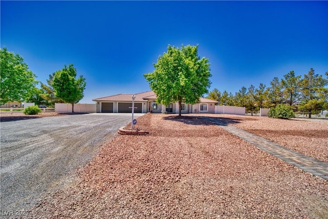1131 China St, Pahrump, NV 89048 - view of front of home with an attached garage and gravel driveway