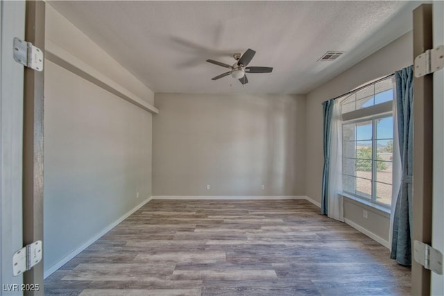 1131 China St, Pahrump, NV 89048 - unfurnished room with a ceiling fan, wood finished floors, and baseboards