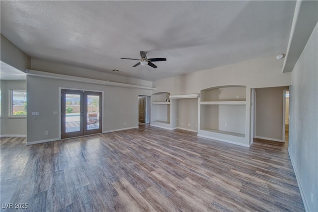 1131 China St, Pahrump, NV 89048 - unfurnished living room featuring wood finished floors, ceiling fan, baseboards, and french doors