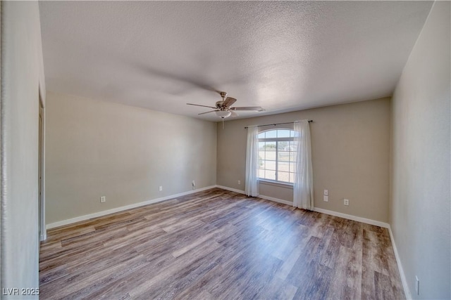 1131 China St, Pahrump, NV 89048 - unfurnished room with ceiling fan, wood finished floors, baseboards, and a textured ceiling