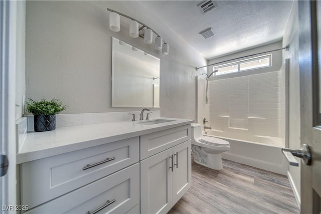 1131 China St, Pahrump, NV 89048 - full bath featuring toilet, wood finished floors, a textured ceiling, vanity, and shower / bath combination