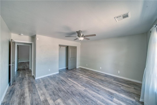 1131 China St, Pahrump, NV 89048 - unfurnished bedroom with wood finished floors, a closet, baseboards, and a ceiling fan
