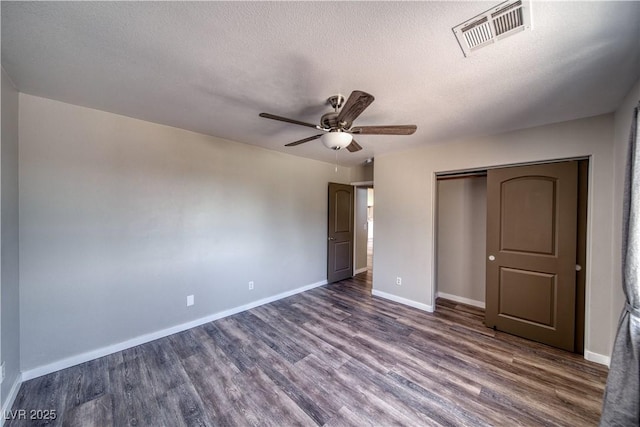 1131 China St, Pahrump, NV 89048 - unfurnished bedroom featuring dark wood-style floors, baseboards, a closet, a textured ceiling, and ceiling fan
