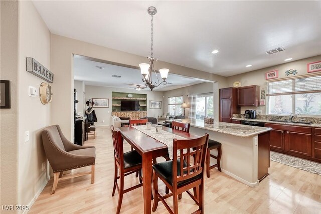 dining space featuring light wood finished floors, a notable chandelier, visible vents, and recessed lighting