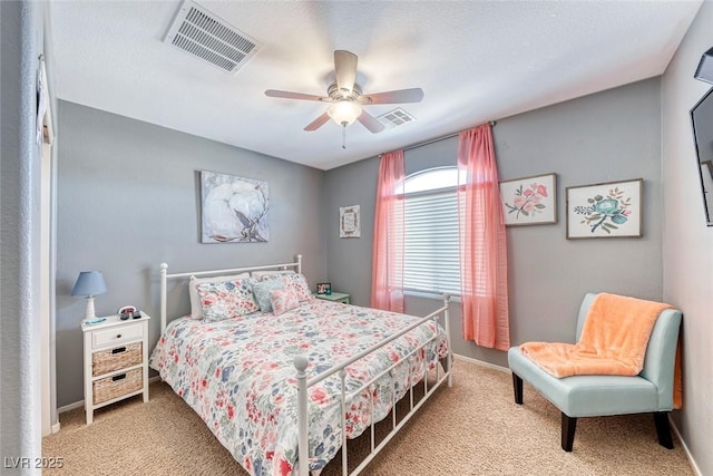 bedroom with baseboards, visible vents, ceiling fan, and carpet