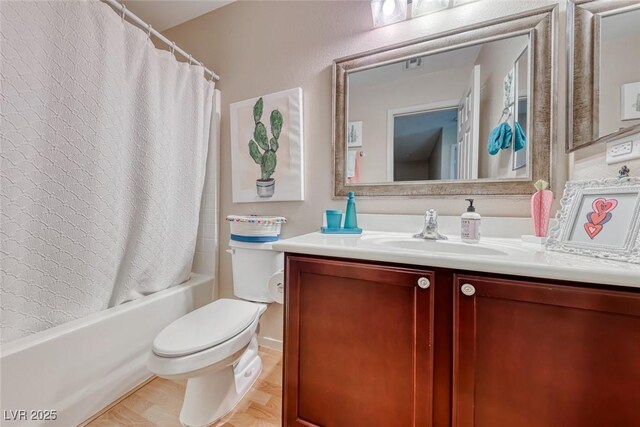 full bath with visible vents, toilet, vanity, and shower / bath combo with shower curtain