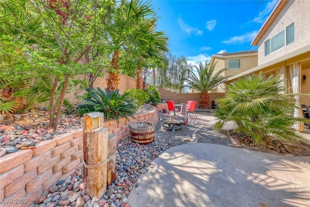 view of patio with a fire pit and fence