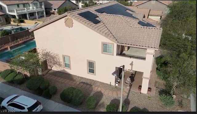 8070 Pavarotti Ave, Las Vegas, NV 89178 - exterior space with stucco siding, solar panels, and a tile roof
