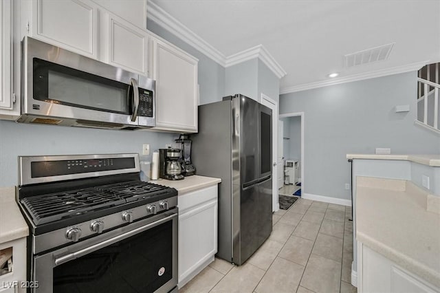 3920 Sweet Pine St Unit 102, Las Vegas, NV 89108 - kitchen with appliances with stainless steel finishes, crown molding, white cabinets, light countertops, and light tile patterned floors