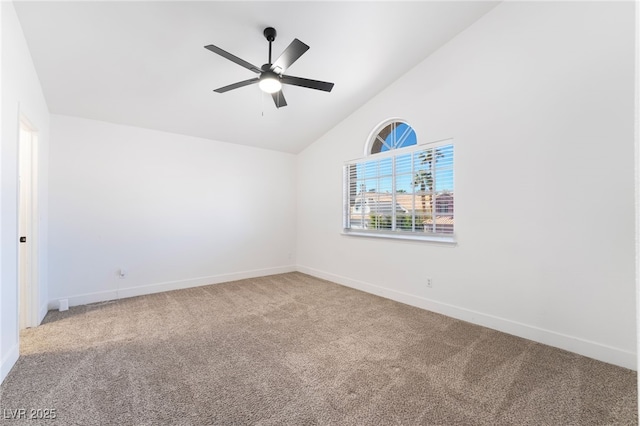 carpeted spare room featuring baseboards, lofted ceiling, and ceiling fan