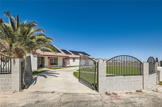 8515 Belcastro St, Las Vegas, NV 89113 - view of front of home featuring a gate, driveway, roof mounted solar panels, and stucco siding