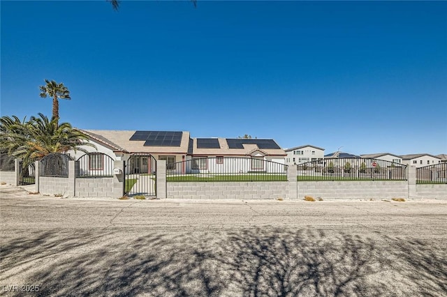 8515 Belcastro St, Las Vegas, NV 89113 - view of front of home with a fenced front yard, solar panels, and a gate