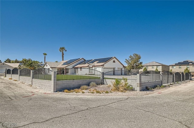 8515 Belcastro St, Las Vegas, NV 89113 - view of side of property featuring a fenced front yard, a residential view, solar panels, and a gate