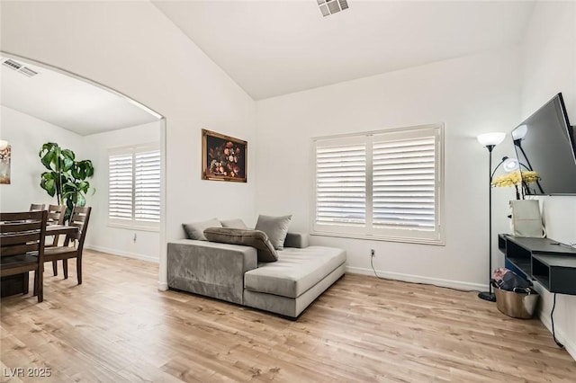 8515 Belcastro St, Las Vegas, NV 89113 - sitting room with vaulted ceiling, arched walkways, light wood-style flooring, and baseboards