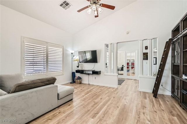 8515 Belcastro St, Las Vegas, NV 89113 - living area with ceiling fan, light wood finished floors, baseboards, and high vaulted ceiling