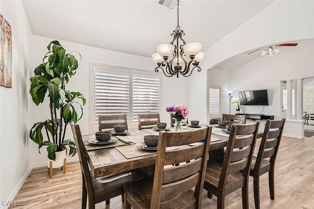 8515 Belcastro St, Las Vegas, NV 89113 - dining room featuring light wood-type flooring, a chandelier, arched walkways, baseboards, and ceiling fan