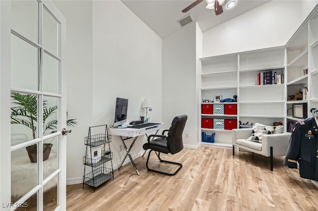 8515 Belcastro St, Las Vegas, NV 89113 - home office with high vaulted ceiling, wood finished floors, a ceiling fan, and baseboards