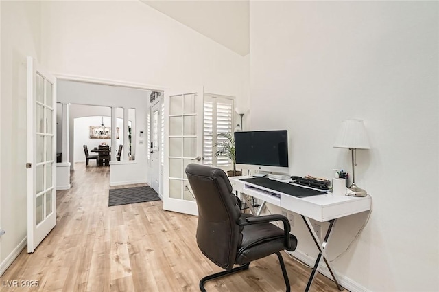 8515 Belcastro St, Las Vegas, NV 89113 - office featuring french doors, light wood-style flooring, baseboards, and a towering ceiling