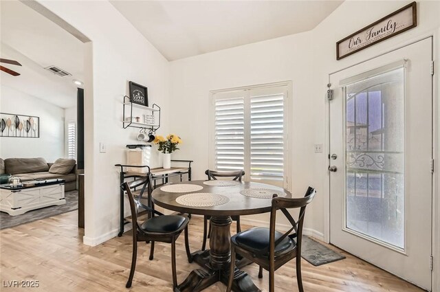 8515 Belcastro St, Las Vegas, NV 89113 - dining space with lofted ceiling, light wood-style floors, a ceiling fan, and baseboards