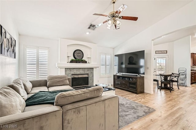 8515 Belcastro St, Las Vegas, NV 89113 - living room with a ceiling fan, vaulted ceiling, a fireplace, light wood-style flooring, and recessed lighting
