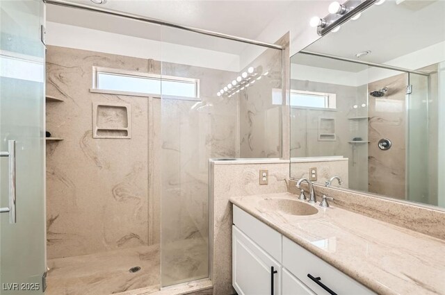 8515 Belcastro St, Las Vegas, NV 89113 - bathroom with a marble finish shower, plenty of natural light, vanity, and tile walls