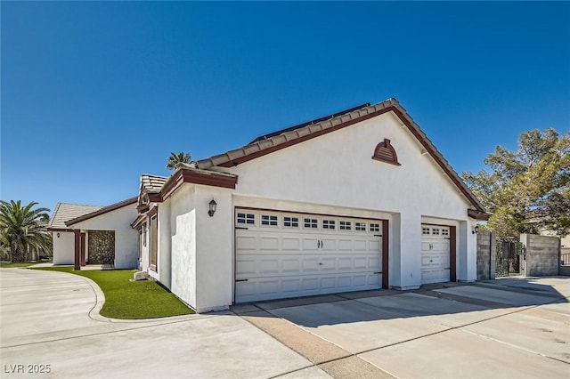8515 Belcastro St, Las Vegas, NV 89113 - view of home's exterior with concrete driveway, an attached garage, and stucco siding