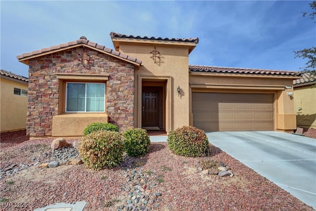 mediterranean / spanish-style house featuring stone siding, concrete driveway, stucco siding, a tiled roof, and a garage