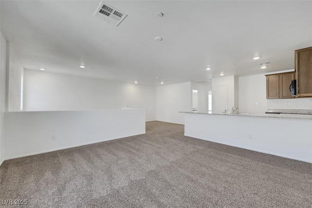 unfurnished living room with carpet and recessed lighting