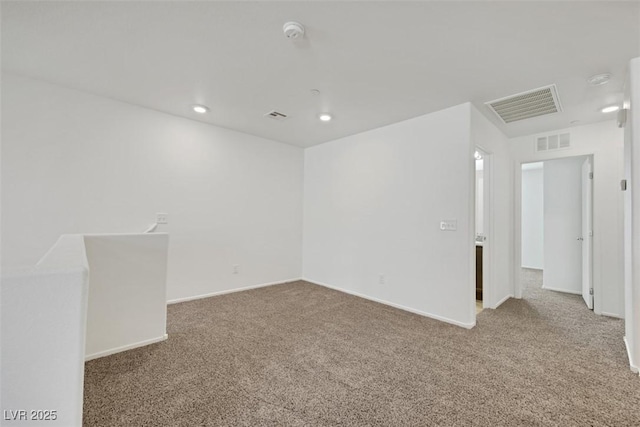 spare room with carpet, a smoke detector, baseboards, and recessed lighting