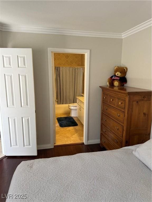2796 Cape Hope Way, Las Vegas, NV 89121 - bedroom with crown molding, dark wood-style flooring, baseboards, and ensuite bathroom