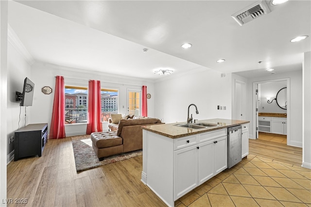 30 Strada Di Villaggio 409, Henderson, NV 89011 - kitchen with light wood-style flooring, stainless steel dishwasher, a sink, visible vents, and white cabinets