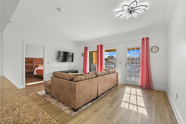 30 Strada Di Villaggio 409, Henderson, NV 89011 - living room featuring baseboards, crown molding, and wood finished floors