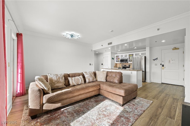 30 Strada Di Villaggio 409, Henderson, NV 89011 - living area with baseboards, ornamental molding, wood finished floors, and recessed lighting