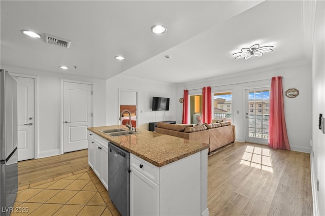 30 Strada Di Villaggio 409, Henderson, NV 89011 - kitchen featuring light wood-style flooring, stainless steel appliances, a sink, visible vents, and white cabinets