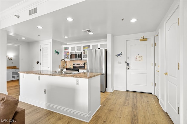 30 Strada Di Villaggio 409, Henderson, NV 89011 - kitchen with a sink, visible vents, light wood-style flooring, and appliances with stainless steel finishes
