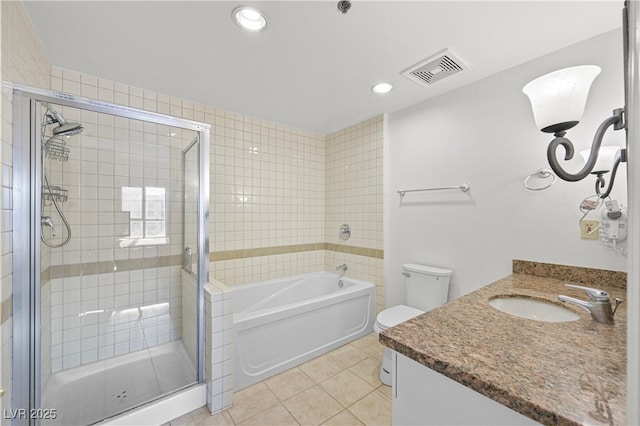 30 Strada Di Villaggio 409, Henderson, NV 89011 - full bathroom featuring toilet, vanity, a shower stall, tile patterned flooring, and visible vents